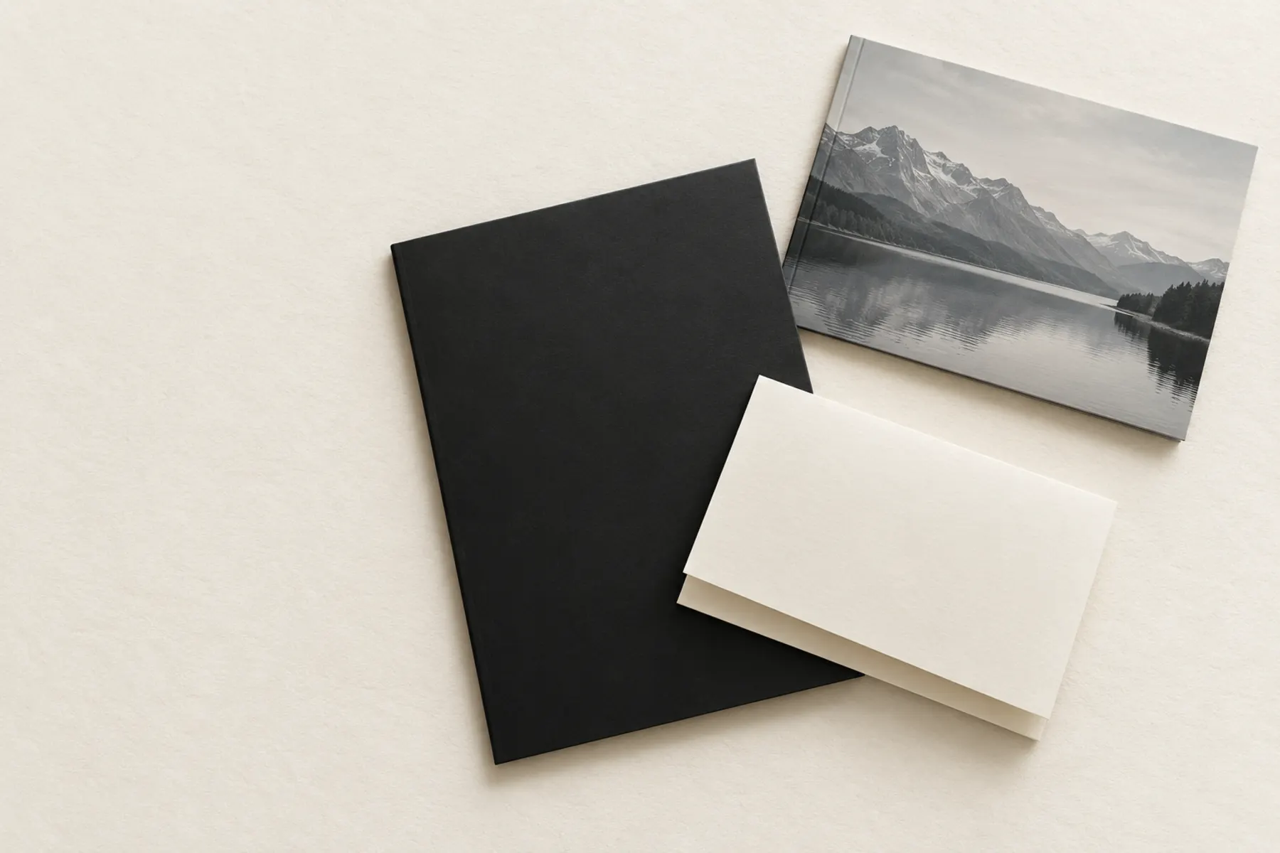 An opened mailer containing a black presentation folder, a printed booklet and a folded letter
